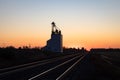 Grain Elevator Silhouetted Against Golden Prairie Sunrise Royalty Free Stock Photo