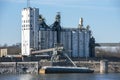 Grain elevator terminal barge spout loading grain corn into barge on Mississippi River Royalty Free Stock Photo