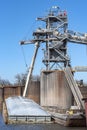 Grain elevator terminal spout loading corn into barge on Mississippi River Royalty Free Stock Photo