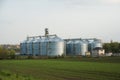 Grain elevators among spring landscape Royalty Free Stock Photo