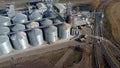 Grain-filled car arrived at grain elevator. Elevator complex of metal structures Royalty Free Stock Photo