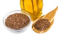 Grain of flax in glass bowl, bottle of oil