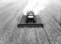 Grain harvester at work. Combine harvester with straw chopper works in the wheat field. Harvesting Wheat in slow motion Royalty Free Stock Photo