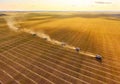 Combine harvesters agricultural machines collecting golden wheat on the field. View from above. Royalty Free Stock Photo