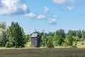 Grain mill on the winter landscape. Windmill and natural background