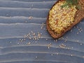 Grain mustard and rye bread on a wooden background