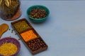 Grain of red and green lentils and beans in a scrambler on a table side view close-up, blue background, Royalty Free Stock Photo