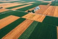 Grain silo building in cultivated field, aerial shot from drone pov