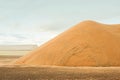 Grain storage silos. Harvest concept. Hill of grain, wheat, rye, barley, corn, rape, etc. Granary with mechanical equipment Royalty Free Stock Photo