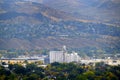 Grainary in Small Town with Railroad Rail Road Mountains and Houses