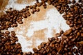 Grains of black coffee lying on a rough canvas. Background for coffee drinks Royalty Free Stock Photo