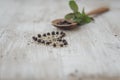 Grains of black Pepper in a wooden spoon Royalty Free Stock Photo