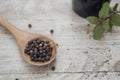 Grains of black Pepper in a wooden spoon Royalty Free Stock Photo