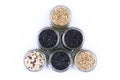Grains of black rice, buckwheat and other cereals in glass jars, top view on a white background Royalty Free Stock Photo
