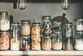 Grains, cereals, nuts, dry fruit, flour, pasta over kitchen counter