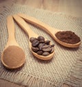 Grains, ground and instant coffee with wooden spoon on jute canvas Royalty Free Stock Photo