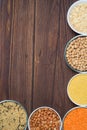 Grains red lentils, basmati rice, buckwheat, chickpeas, millet in plates. organic healthy cereals. on a wooden background. natural Royalty Free Stock Photo