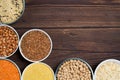 Grains red lentils, basmati rice, buckwheat, chickpeas, millet in plates. organic healthy cereals. on a wooden background. natural Royalty Free Stock Photo