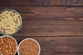 Grains red lentils, basmati rice, buckwheat, chickpeas, millet in plates. organic healthy cereals. on a wooden background. natural Royalty Free Stock Photo