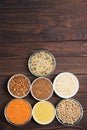 Grains red lentils, basmati rice, buckwheat, chickpeas, millet in plates. organic healthy cereals. on a wooden background. natural Royalty Free Stock Photo