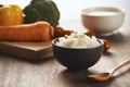 Grains of rice in a wooden bowl and ingredients for a vegetarian Royalty Free Stock Photo