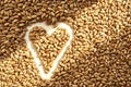 Grains of ripened beautiful wheat in the shape of a heart, harvesting in autumn