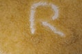 The grains of steamed rice are scattered on the surface and the letter \