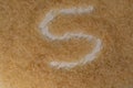 The grains of steamed rice are scattered on the surface and the letter \