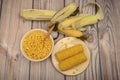 Grains of sweet corn in a plate with a wooden spoon, coarse salt and ears of corn on the table. Healthy diet. Fitness diet. For a Royalty Free Stock Photo