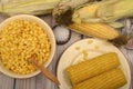 Grains of sweet corn in a plate with a wooden spoon, coarse salt and ears of corn on the table. Healthy diet. Fitness diet. For a Royalty Free Stock Photo