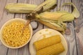 Grains of sweet corn in a plate with a wooden spoon, coarse salt and ears of corn on the table. Healthy diet. Fitness diet. For a Royalty Free Stock Photo