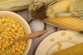 Grains of sweet corn in a plate with a wooden spoon, coarse salt and ears of corn on the table. Healthy diet. Fitness diet. For a Royalty Free Stock Photo