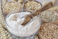 Grains: grains of wheat and oats, ears of wheat on sackcloth. Flour in a glass cup