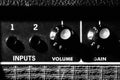 Grainy black and white artistic vintage style guitar amplifier elements, featuring close up of control knobs. Royalty Free Stock Photo