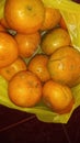 grainy and blurry picture of orange fruit bunch of oranges round yellow skin fruit