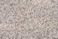 Grainy kitchen countertop top view. Surface of spotted empty table, abstract background with small black and white stones, rough