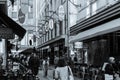 Grainy old-fashioned style image Degraves Street laneway with its, cafes, shops and characteristic signage as people walk through