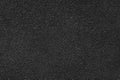 Grainy texture of black colored asphalt, plaster, cement, plastic close up, macro background Royalty Free Stock Photo