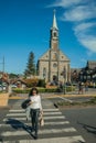 Church facade and people in a street of Gramado