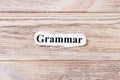 Grammarof the word on paper. concept. Words of Grammar on a wooden background