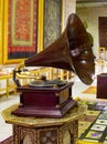 Gramophone is an Music device. Old gramophone with plate or vinyl disk on wooden box. Antique brass record player. Gramophone with