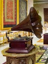 Gramophone is an Music device. Old gramophone with plate or vinyl disk on wooden box. Antique brass record player. Gramophone with