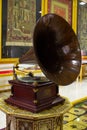 Gramophone is an Music device. Old gramophone with plate or vinyl disk on wooden box. Antique brass record player. Gramophone with