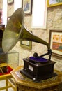 Gramophone is an Music device. Old gramophone with plate or vinyl disk on wooden box. Antique brass record player. Gramophone with