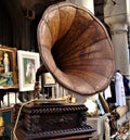 Gramophone with plate or vinyl disk on wooden box. Antique brass record player.