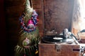 Gramophone playing a record. with vinyl on background decorations, cap, tree and bright lights Royalty Free Stock Photo