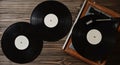 Gramophone and vinyl discs on a wooden floor. Retro media