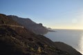 Gran Canara surrounded by the sea with rocks on the background under sunlight Royalty Free Stock Photo