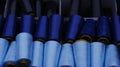 Gran rolls, partly covered with dust, in shades from light blue to dark blue, stored a box. raw material for handicraft