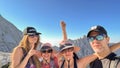 GRAN SASSO, ITALY - AUGUST 23, 2023: Portrait of four happy hikers along the pathway to the summit of Gran Sasso massif